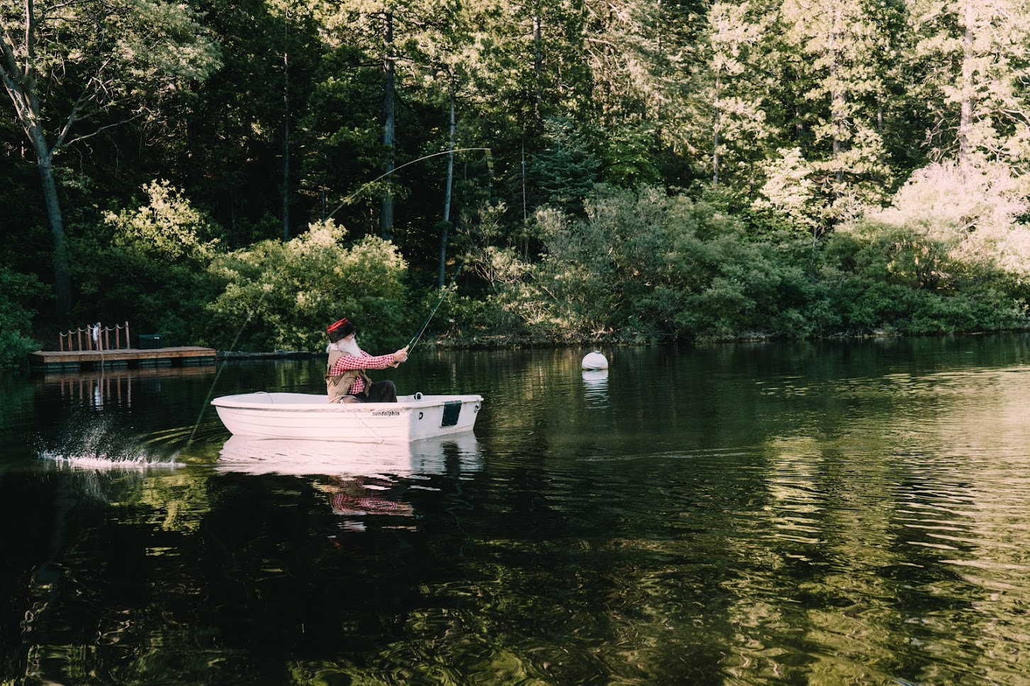 Santa Claus fly-fishing in a boat