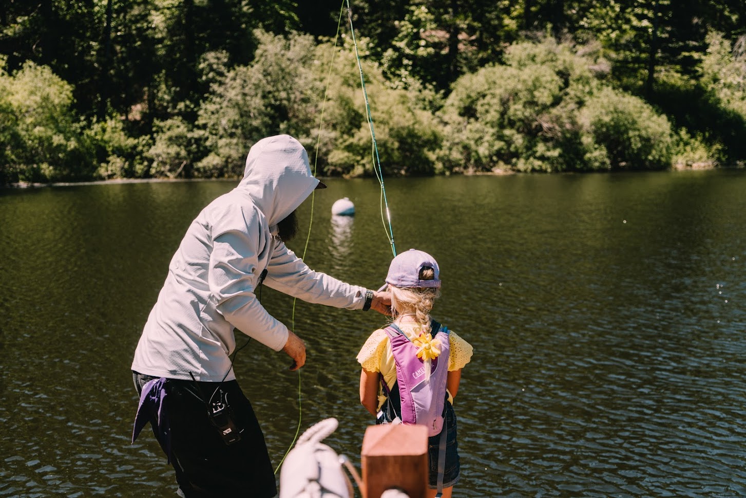 Man teaching a girl to fly fish