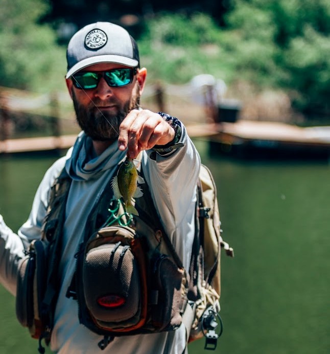 Fly-fishing instructor holding a fish