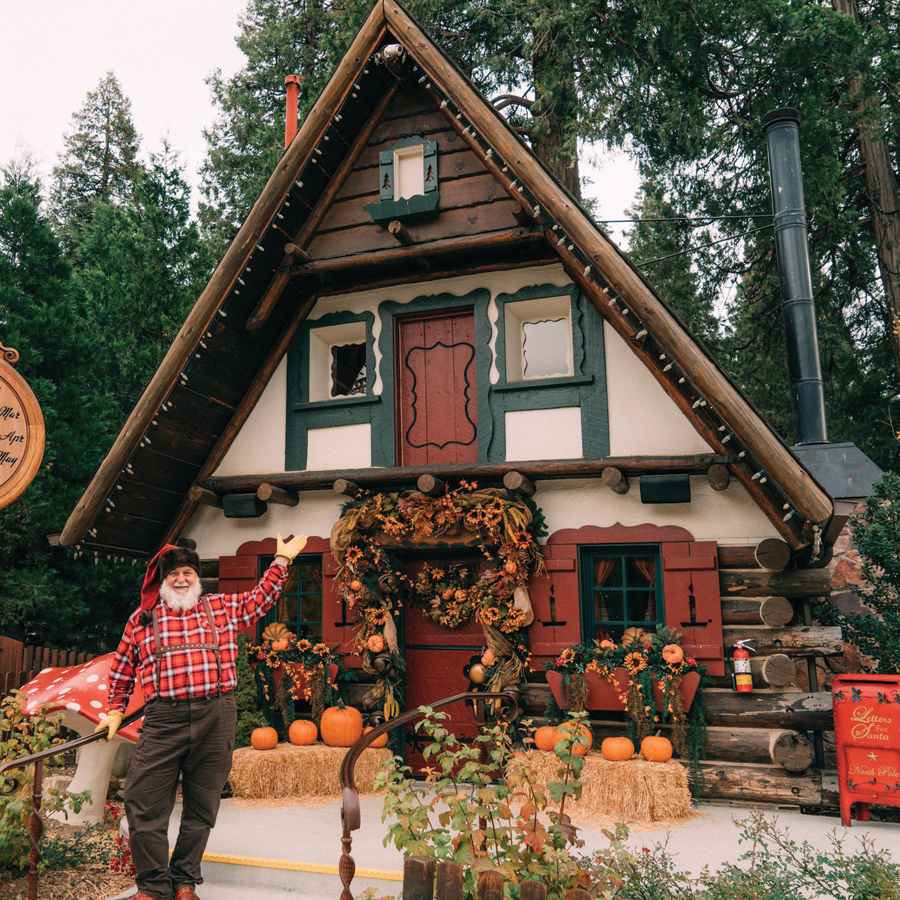 Santa Claus stands in front of his house