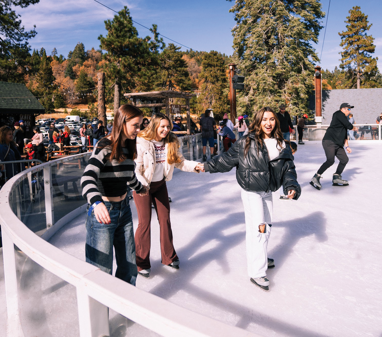 Three smiling ice skaters